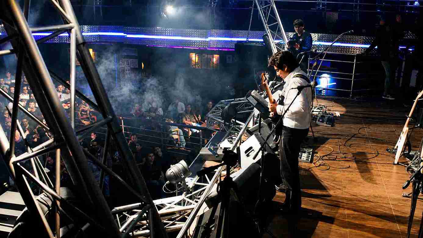 Val Staccato live concert stage full audience Lima Peru instrumental rock guitarist white shirt performing electric guitar